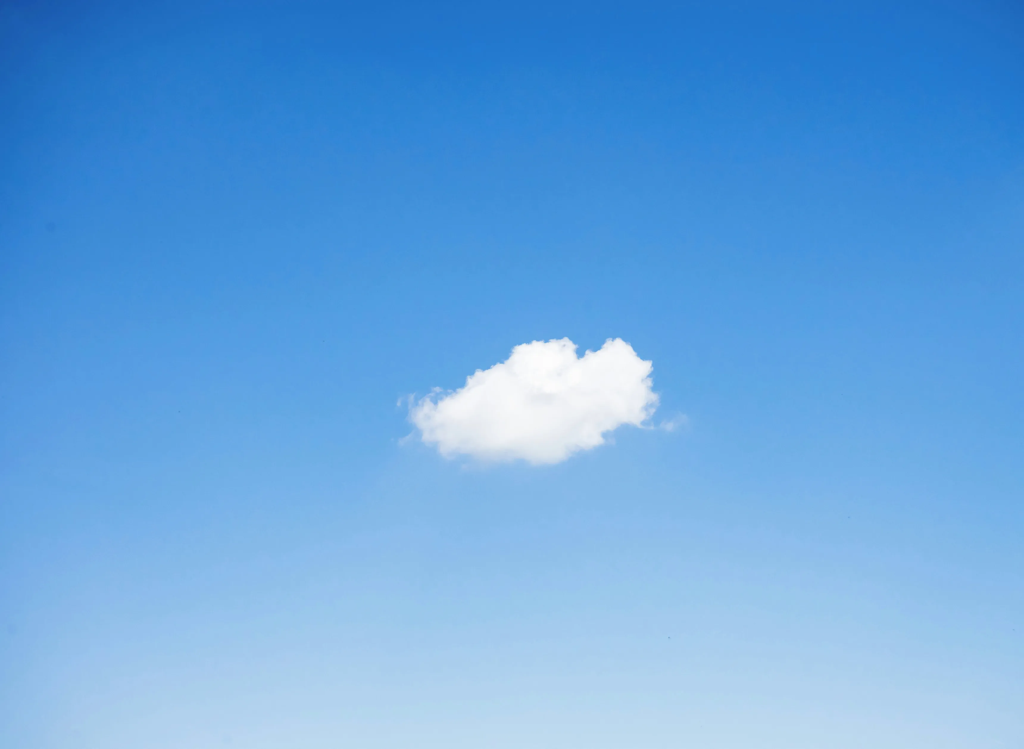 A single cloud in a blue sky